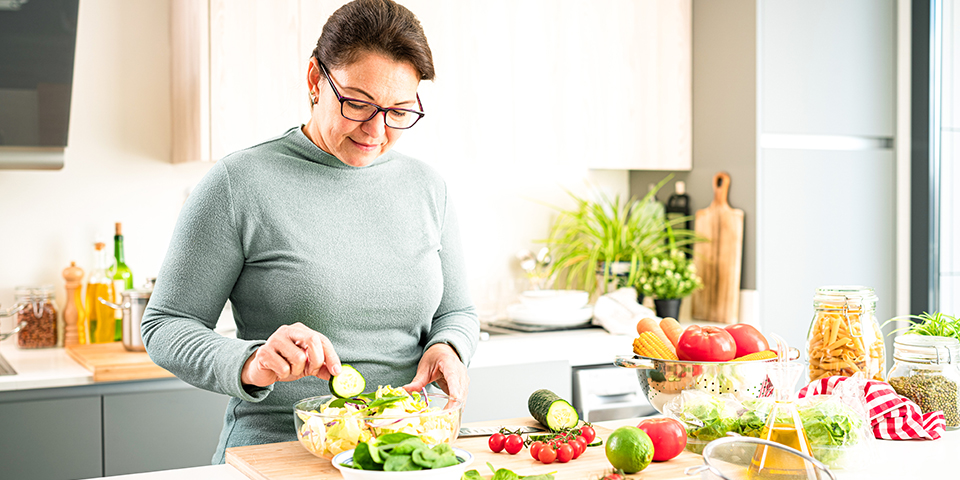 Woman prepping food in a bright kitchen