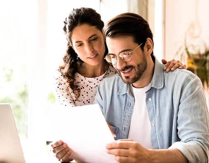 Male and female couple viewing a document