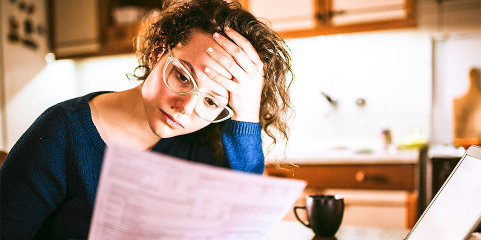 Woman looking distressed while viewing a document