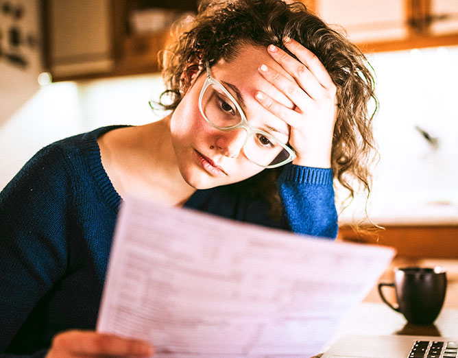 Woman looking distressed while viewing a document