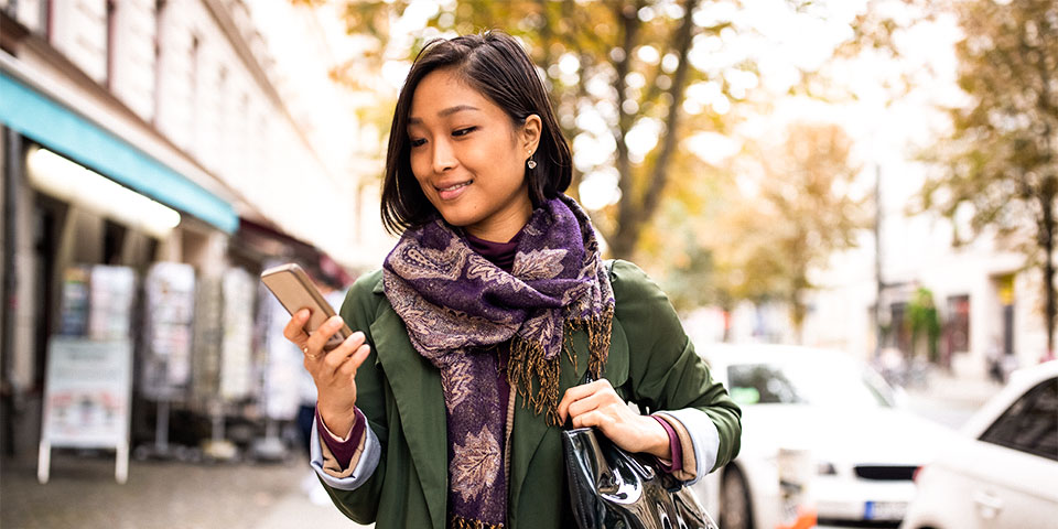 Adult female views information on her smartphone